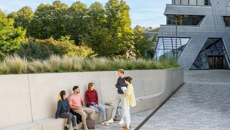 Master students in front of the central building